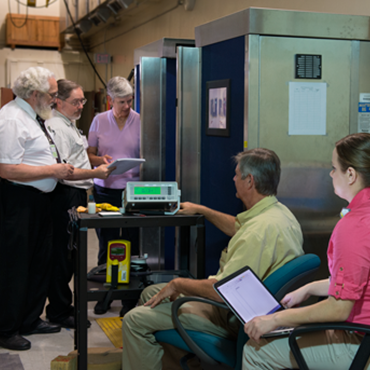 Members of the NAS team and National Academies representatives with the NIST scanner.