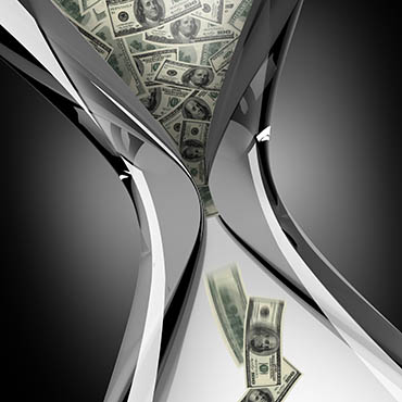 Shutterstock image (by bioraven): hourglass with dollar bills falling through it.