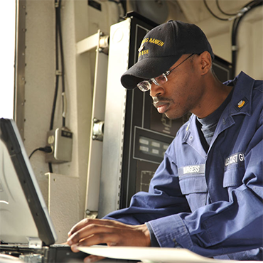 Coast Guardsman using laptop