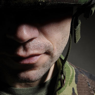 Shutterstock image: soldier's shadowed face.