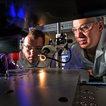 Lawrence Livermore National Laboratory (LLNL) engineers Eric Duoss (left) and Tom Wilson use an additive manufacturing process called direct ink writing to develop an engineered “foam” cushion. Photo by George Kitrinos/LLNL