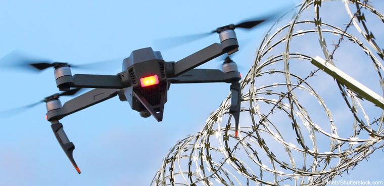 drone by barbed wire fence (Kletr/Shutterstock.com)