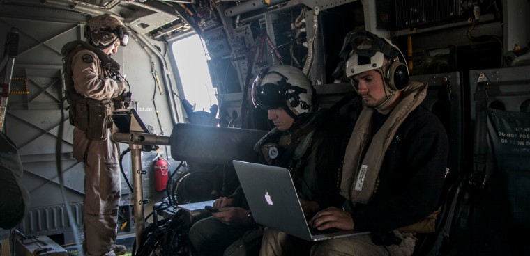 (U.S. Marine Corps photo by Cpl. Elize McKelvey) A contractor supporting the 15th Marine Expeditionary Unit uses a digital interoperability system aboard an MV-22B Osprey during Certification Exercise (CERTEX) off the coast of San Diego, April 19, 2015. 