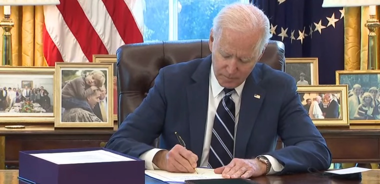 President Joe Biden signs the American Rescue Plan Act in the Oval Office, March 11, 2021