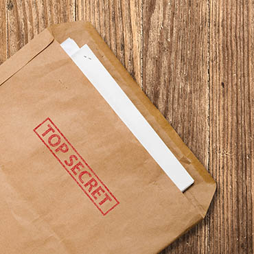Shutterstock image (by elnavegante): open envelope with top secret stamped across its cover.