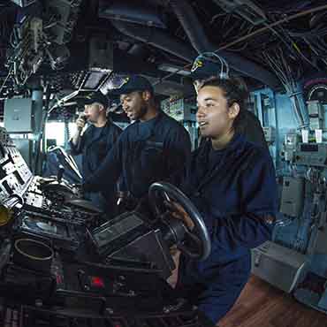 Image copyright to the Navy: Sailors man the bridge helm station to the Arleigh Burke-class guided-missile destroyer USS Mustin (DDG 89) during a replenishment-at-sea.