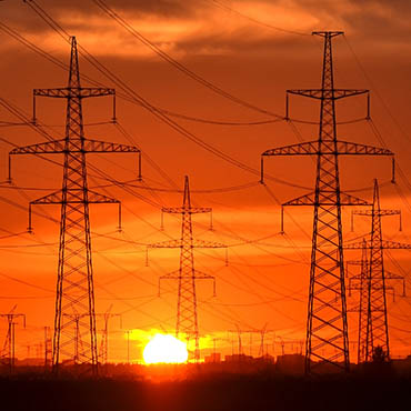 Shutterstock image (by konstantinks): electic power transmission lines at sunset.