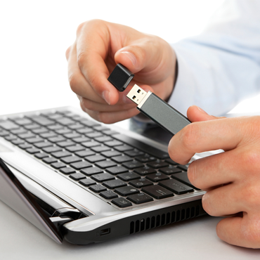 USB stick and laptop (Shutterstock.com)