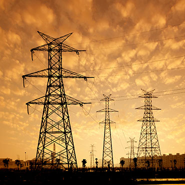 Shutterstock image (by gyn9037): High voltage towers, electricity infrastructure.