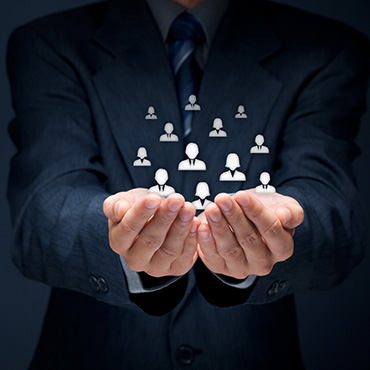 Shutterstock image: businessman holding workforce icons in his hands.